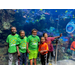 boys lined up in front of an aquarium